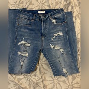 Straight leg light denim jeans. Lightly distressed.